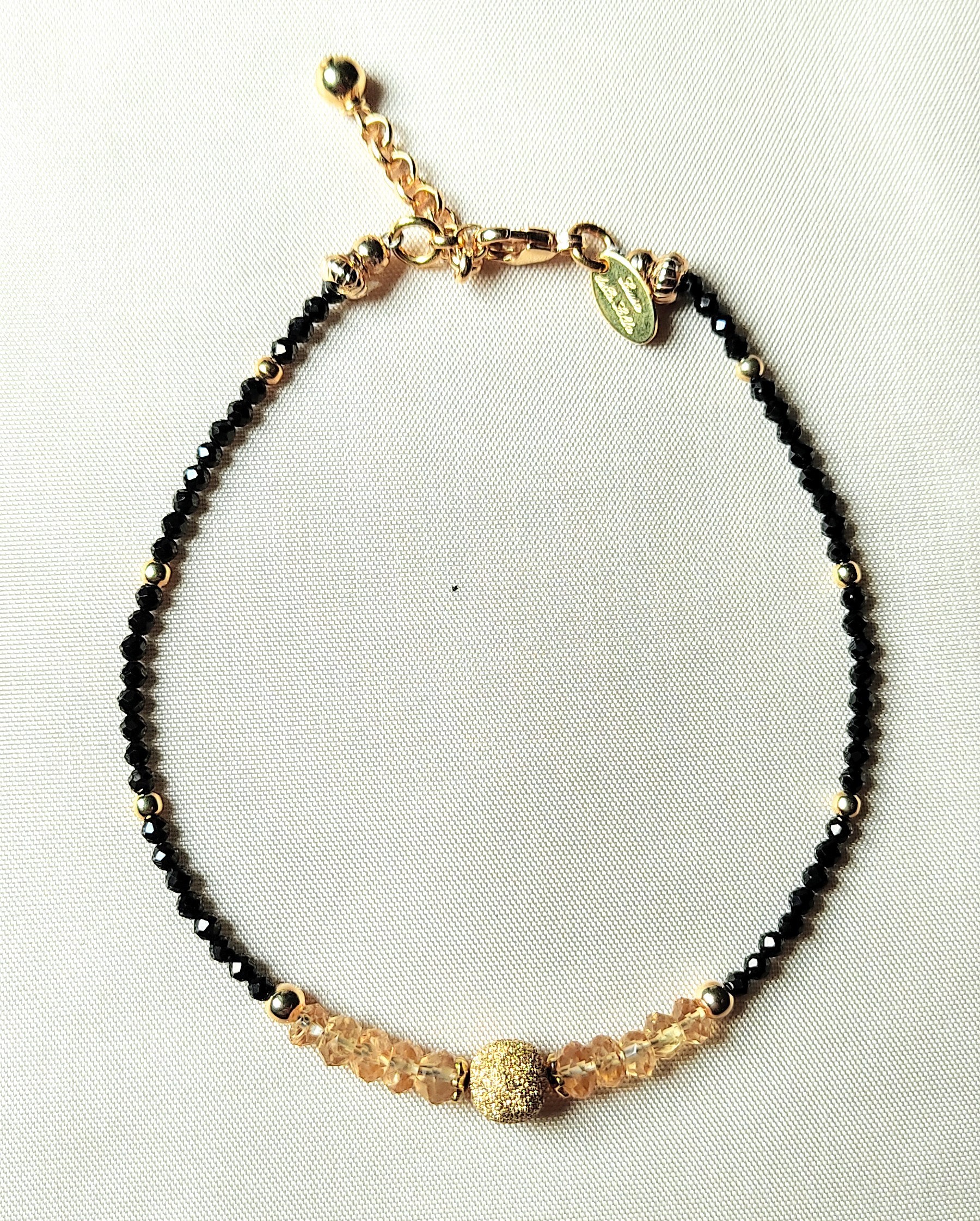 Bracciale con rondelle di quarzo citrino, spinello nero e argento placcato oro